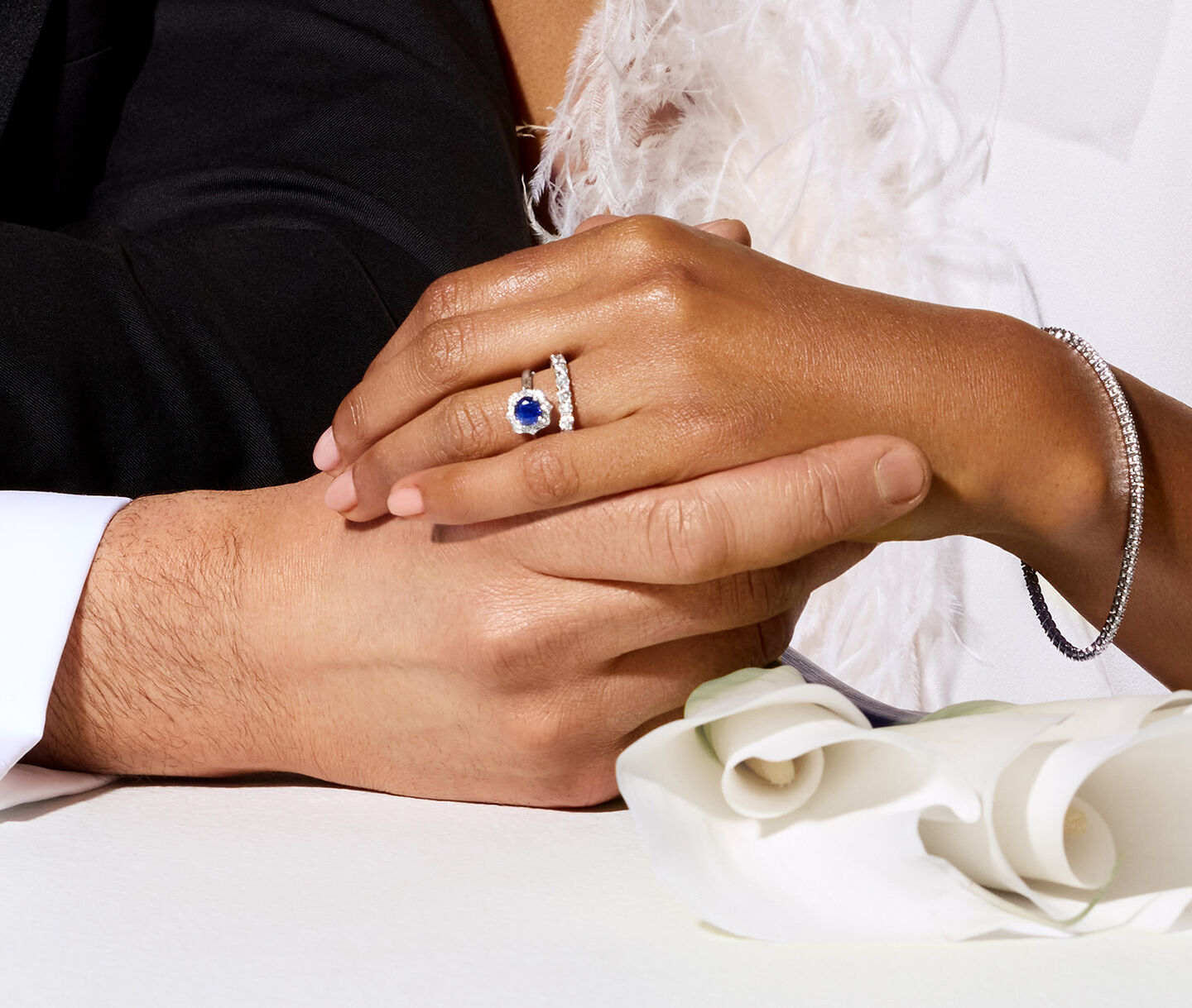 A married couple wearing Birks bridal jewellery. 